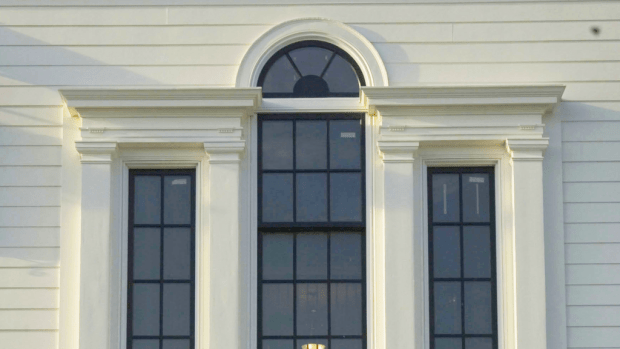The Serliana window that lights the three-story stair hall at Chadsworth Cottage on Figure Eight Island in Wilmington, North Carolina, that was designed by architect Christine Huckins Franck is framed with Chadsworth Incorporated’s Tuscan pilasters.