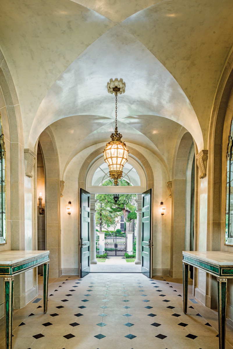 The view from the entrance hall through the open front doors to the front gates and St. Charles Avenue beyond. The stone paving has a pattern of black onyx cabochons.