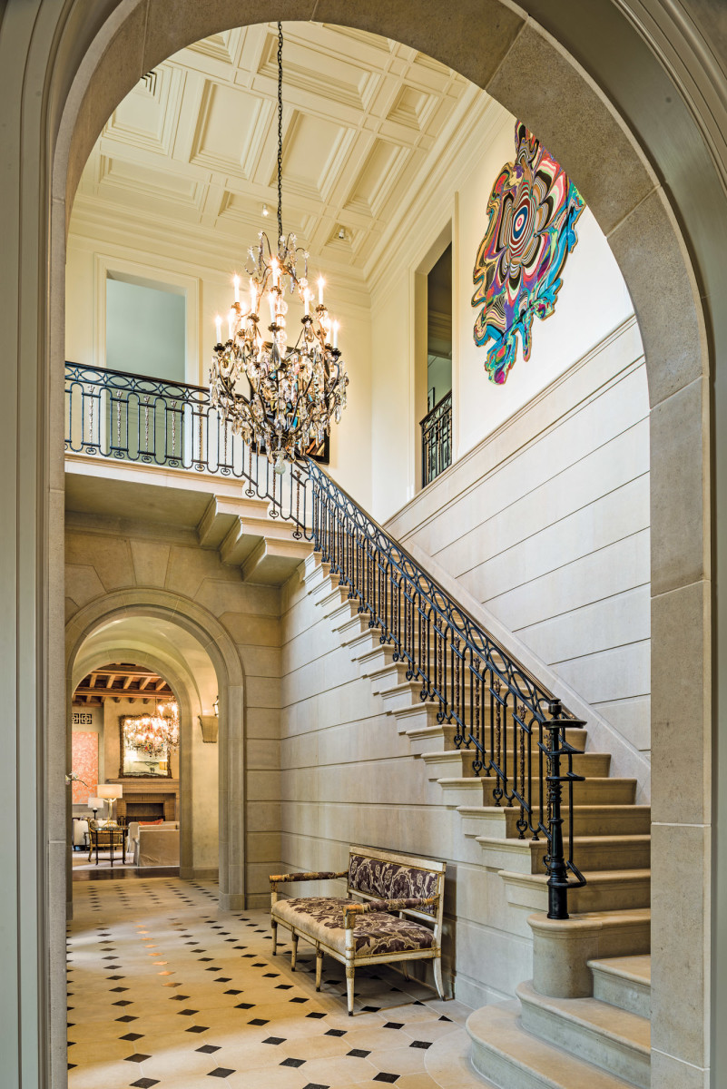  A hand forged iron and cast bronze rail adds open air delicacy to the central cut-stone stair.