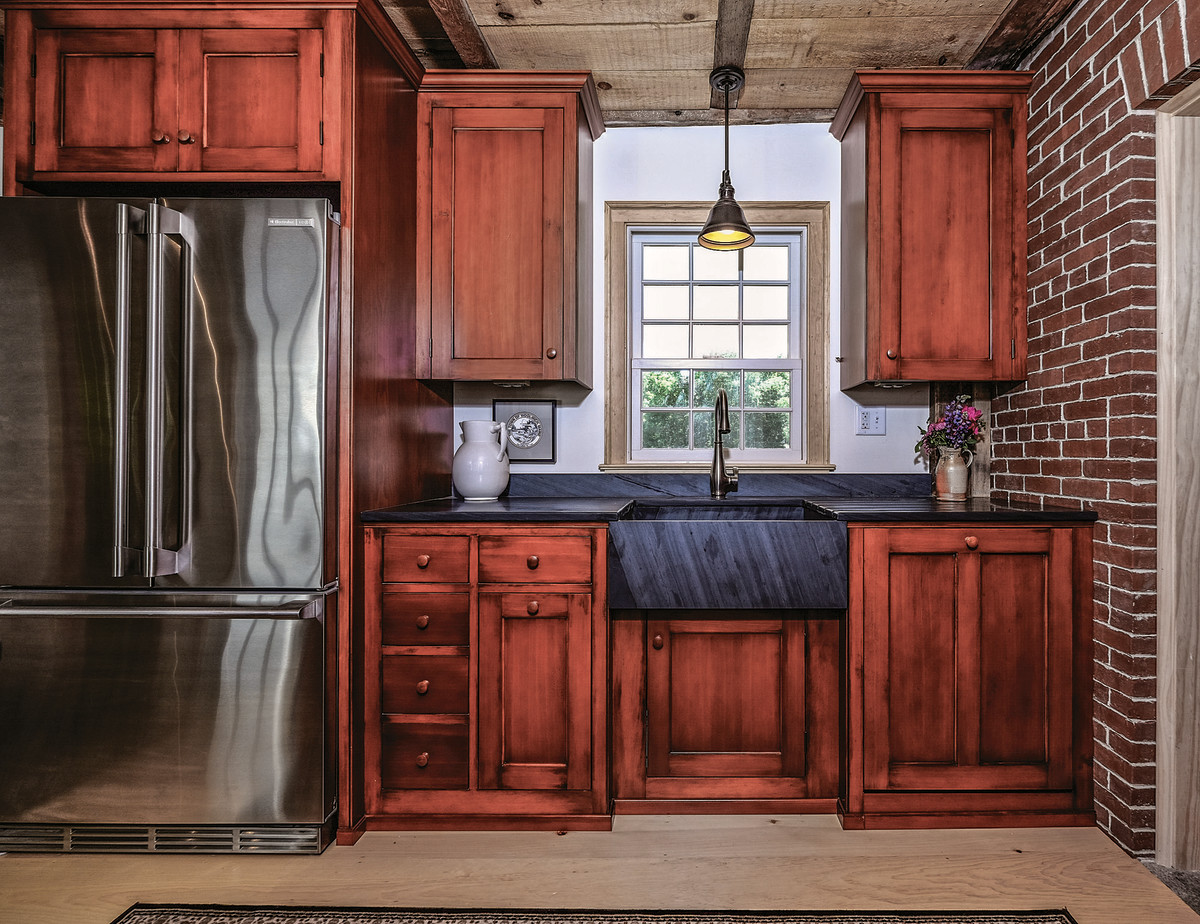 These cabinets are shown in a rich, deep stain, which gives the illusion of age and patina.