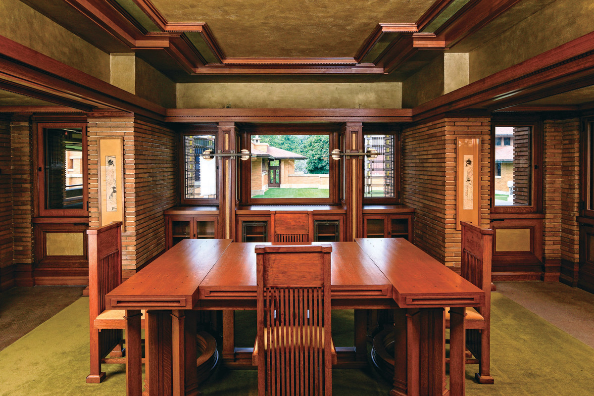 View of dining room with Wright designed table and chairs in the Darwin D. Martin House. The restoration of this and many other rooms required the artistic blending of new and restored wood trim.